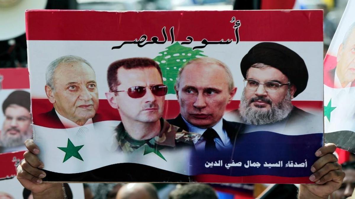 A rally was held this week in front of the Russian embassy in Beirut, Lebanon, to thank Moscow for its intervention in Syria. A Syrian who lives in Lebanon held up a poster with photos of (from left) Lebanese Parliament Speaker Nabih Berri, Syrian President Bashar al-Assad, Russian President Vladimir Putin and Hezbollah leader Sheikh Hassan Nasrallah. The Arabic words at the bottom right read, “Lions of the time.”