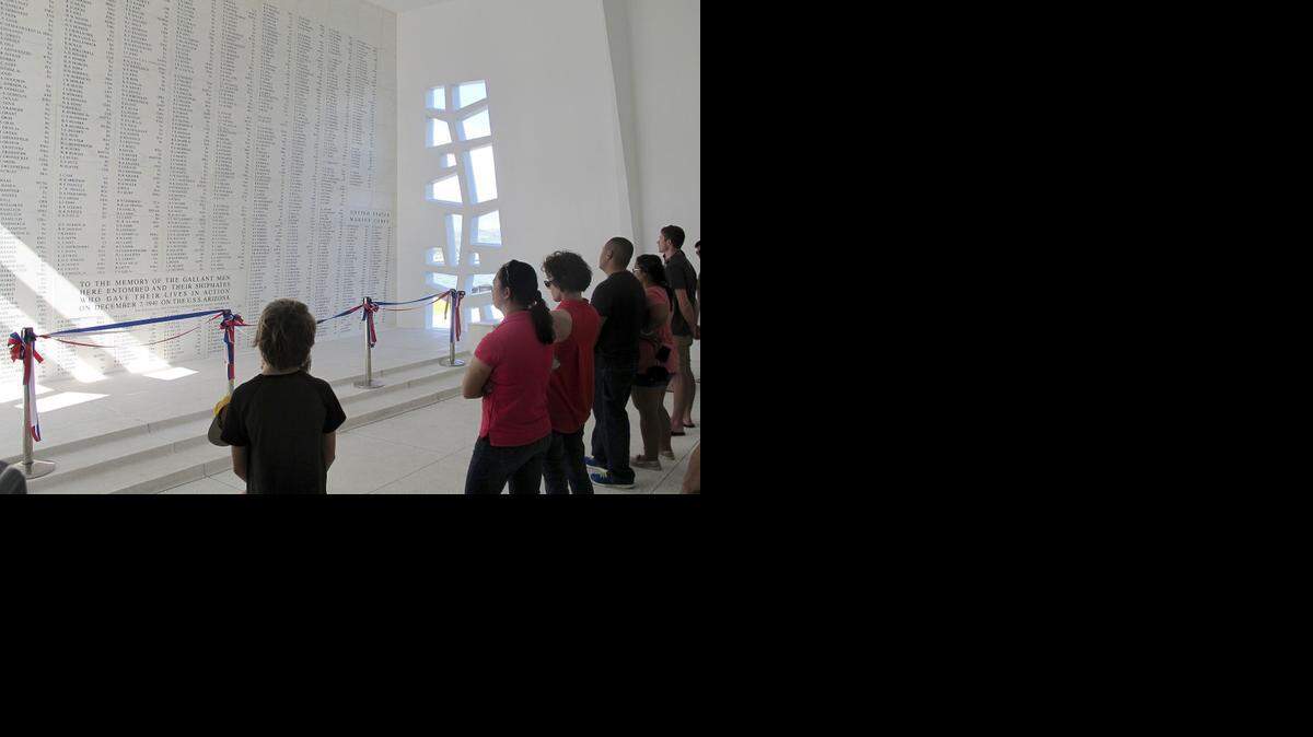 
This Nov. 21, 2014 photo shows visitors looking at a wall inscribed with the names of the U.S.S. Arizona’s fallen at a memorial for the sunken battleship in Pearl Harbor, Hawaii. The USS Arizona is one of the nation’s most hallowed sites, an underwater grave for more than 900 sailors and Marines killed when Japan bombed Pearl Harbor and sank their ship in 1941.
