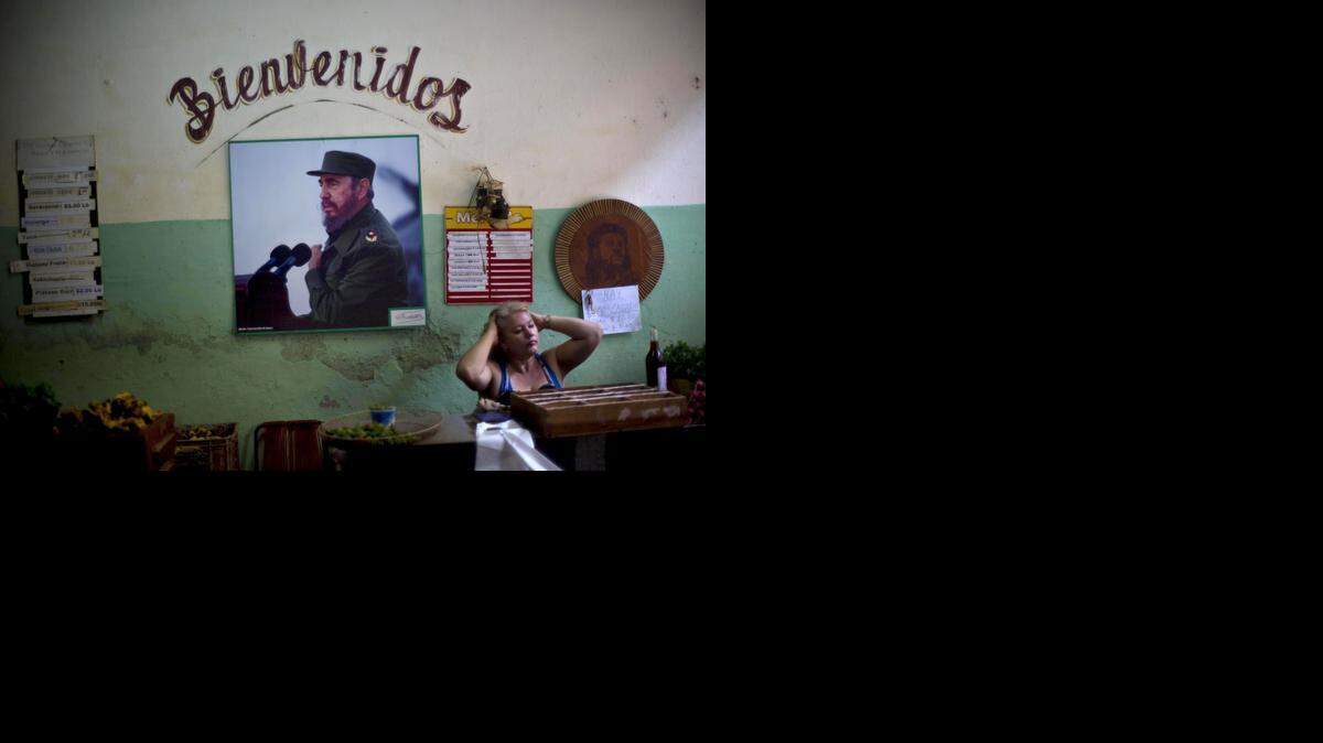 
A photograph of Fidel Castro hangs under the Spanish word “Welcome” on the wall at a state-run food market in Havana, Cuba. On Monday, Castro made his first public comments about the news that the U.S. and his island nation will restore diplomatic relations after more than 50 years of hostility.

