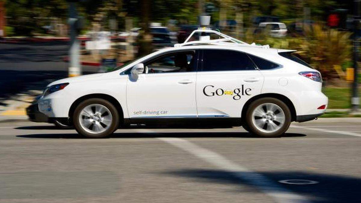 
A man sits in a Google self-driving car in front of the company’s headquarters in Mountain View, Calif.
