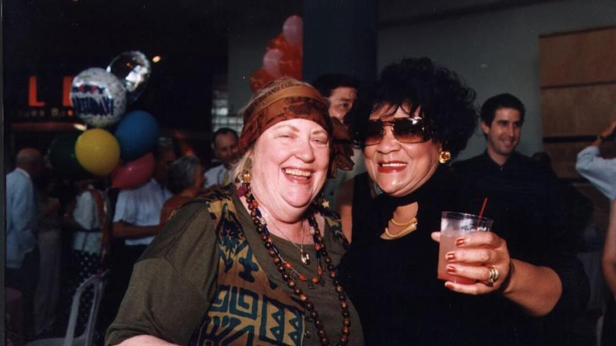 Longtime society editor Laura Hockaday put a wider variety of faces in The Star than readers had seen in the past. In this 1998 photo, she enjoys a laugh with businesswoman and civic leader Georgia Buchanan.