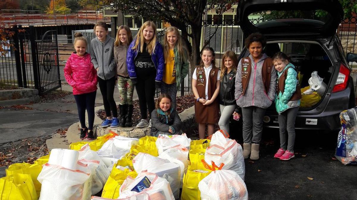 Local groups such as these Girl Scouts in the Brownie program volunteer to distribute hygiene products with KC for Refugees.