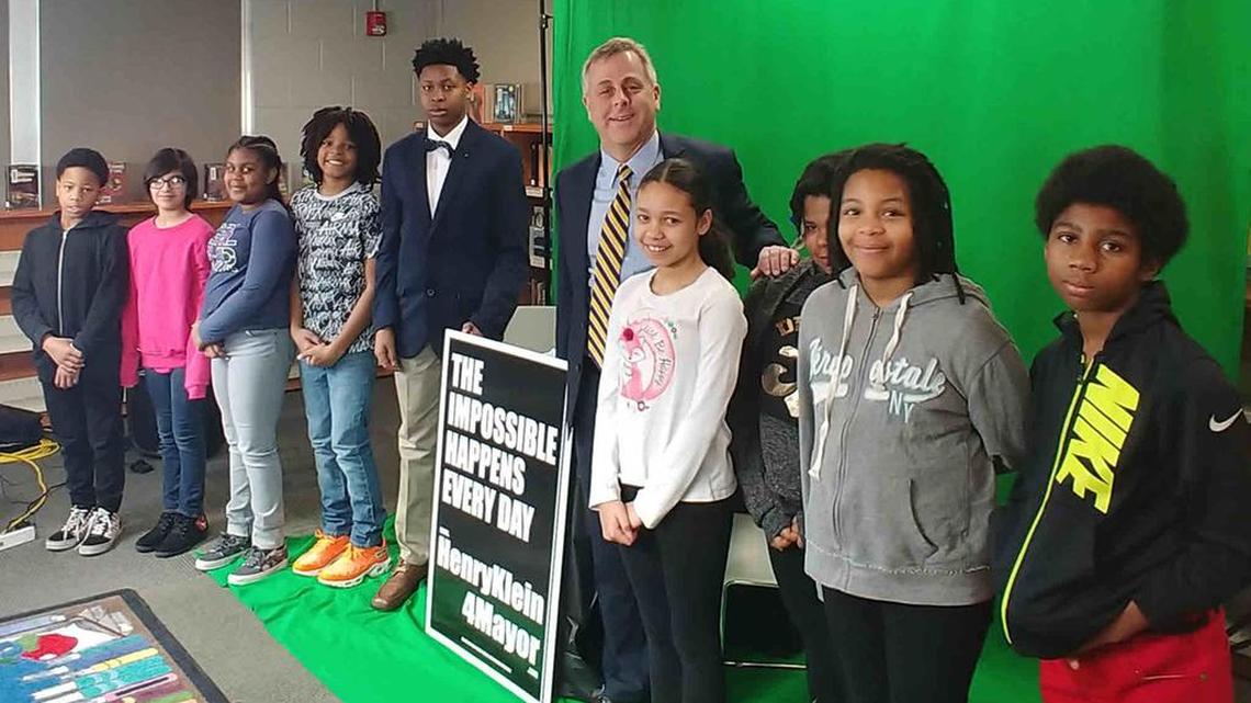 Kansas City mayoral candidate Henry Klein poses with students on a visit to Symington Elementary School in February.