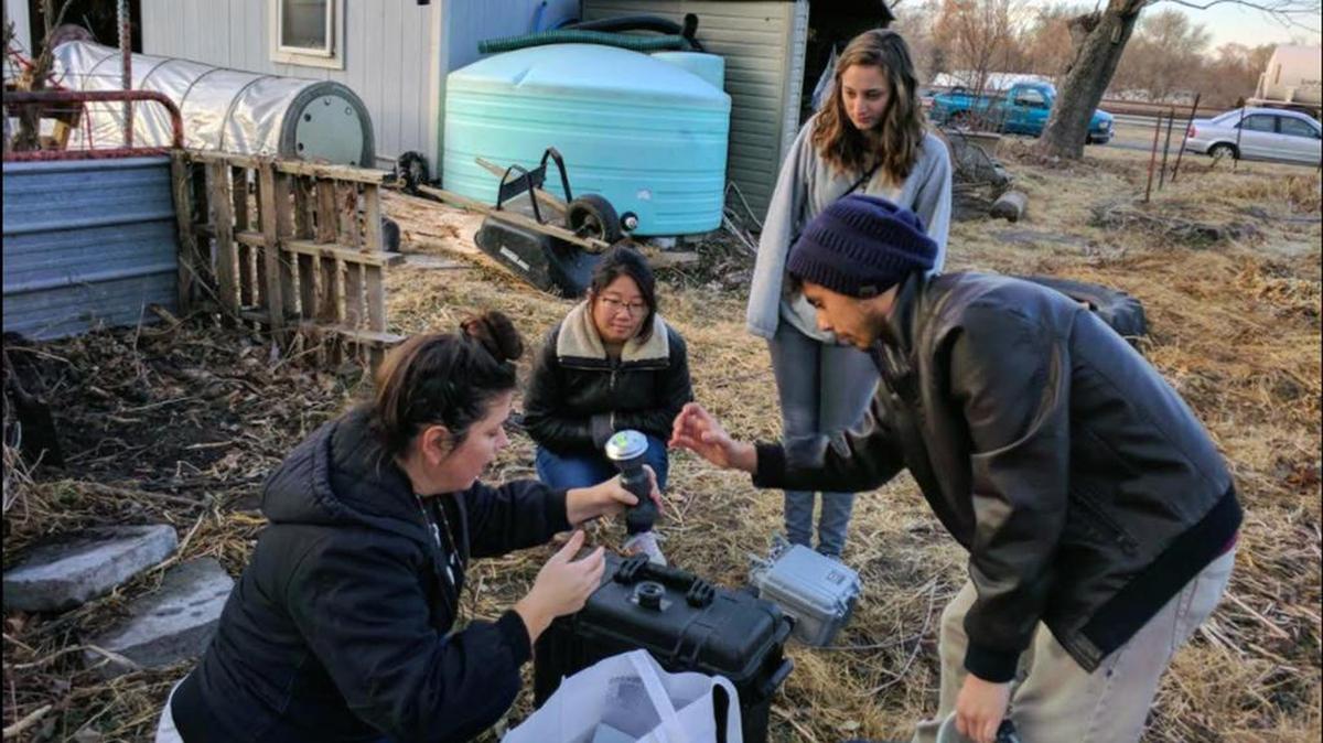 Volunteers with CleanAirNow set up an air quality monitor for Kansas City, Kansas.