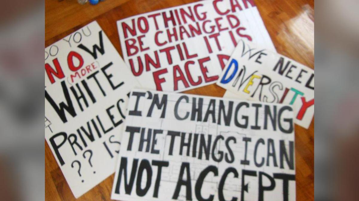 Janine Clark-Barry carries these signs to the center of tiny Willard, Missouri, to stand up for social justice and equity.