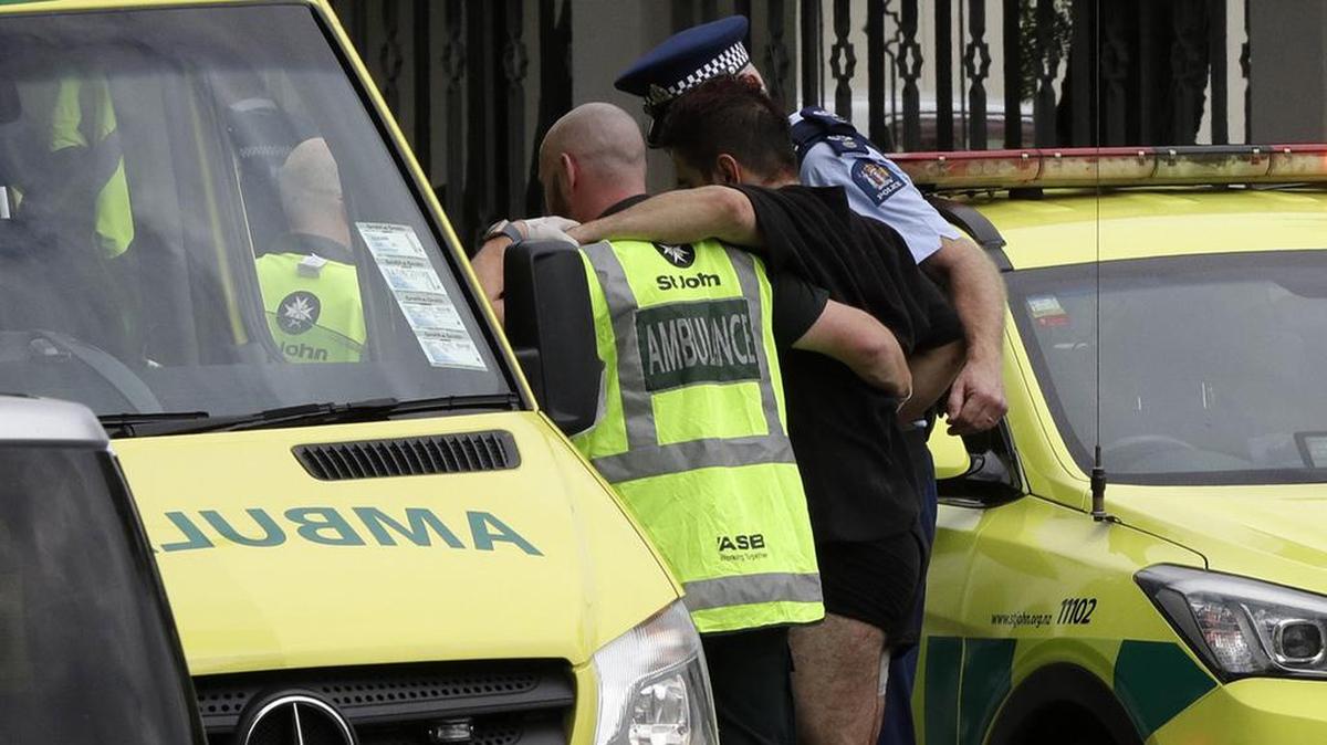 Police and ambulance staff help a wounded man from outside a mosque in central Christchurch, New Zealand, Friday, March 15, 2019.