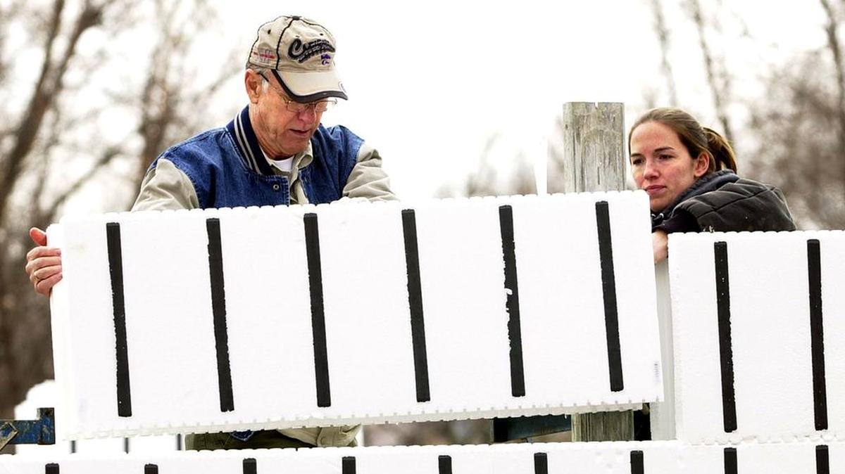 In this 2004 file photo, U.S. Sen. Pat Roberts of Kansas, left, and Shelly Williams of St. Louis placed foam concrete forms while they helped construct a house for Kaw Valley Habitat for Humanity in Kansas City, Kansas.