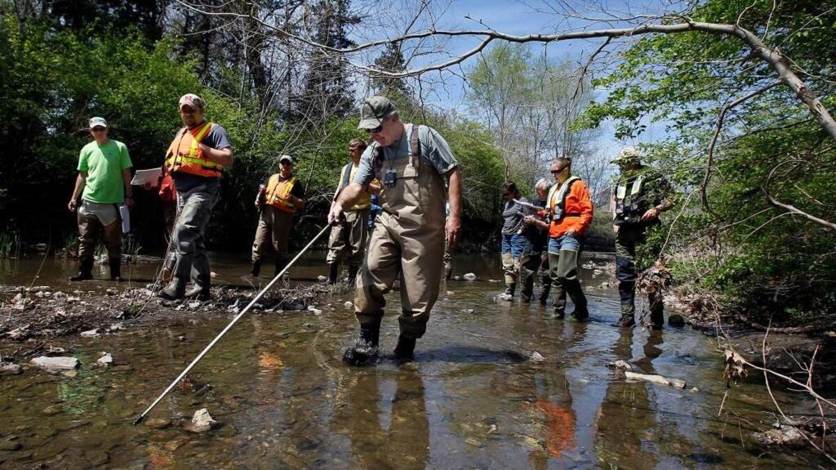 Employees of the Environmental Protection Agency and the United States Geological Survey were led on a river and stream training exercise on April 25, 2013, by Jim Stricko (center) of the Great Lakes Environmental Center.