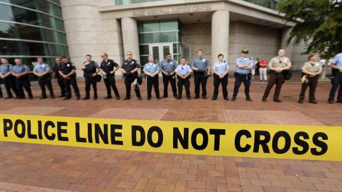 
Police on Wednesday guarded the entrance to the Buzz Westfall Justice Center in Clayton, Mo., where a grand jury is expected to consider charges against the Ferguson police officer who fatally shot 18-year-old Michael Brown.
