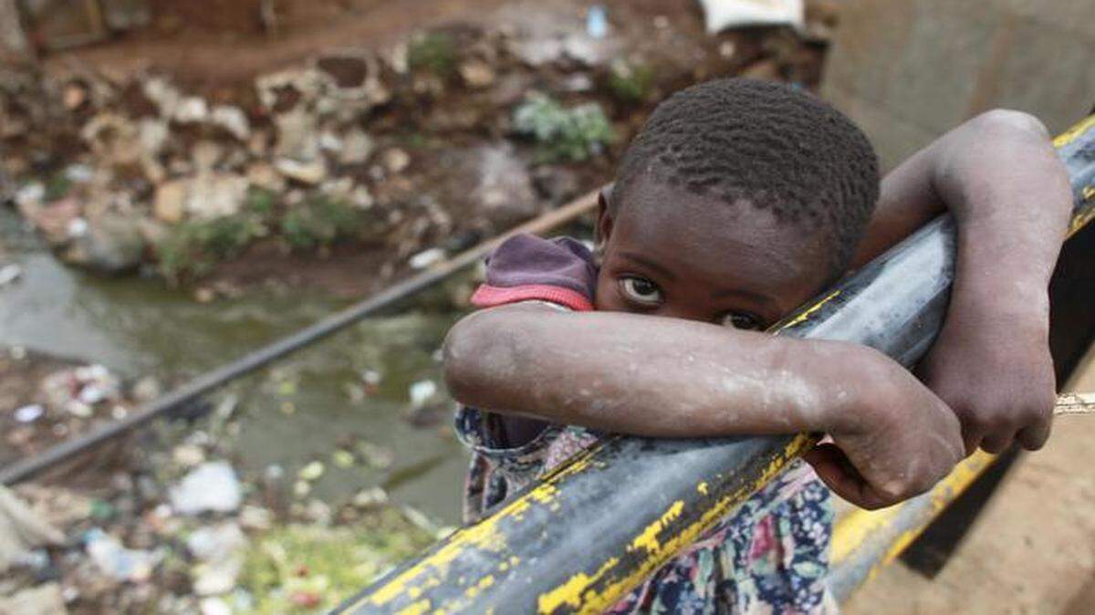 
A young girl plays on a bridge over a stream of raw sewage in the Kibera slum in Nairobi, Kenya. In most of the slum there are no toilet facilities, with one hole-in-the ground latrine being shared by up to 50 shacks. 
