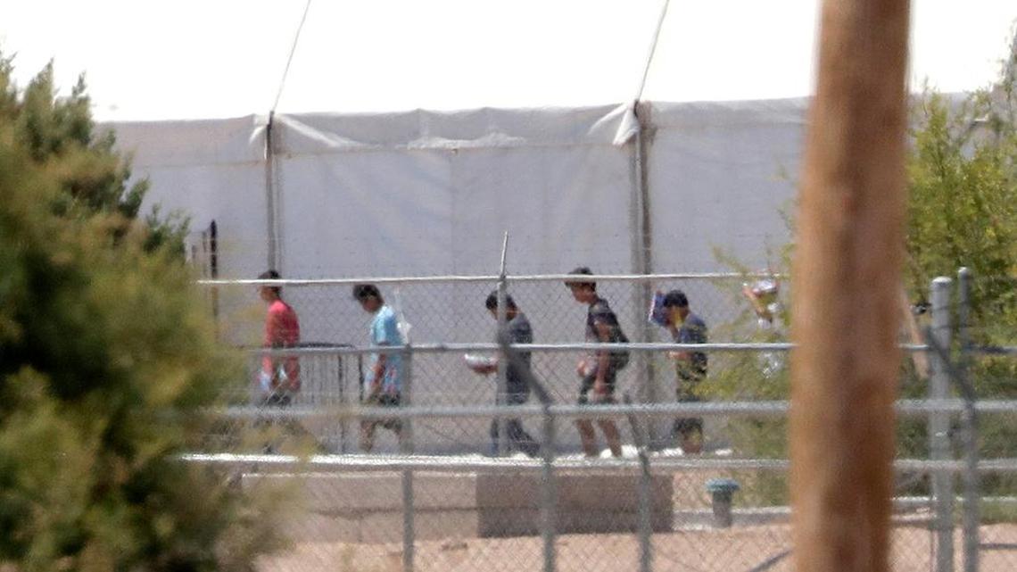 Detainees are seen outside tent shelters used to hold separated family members, Friday, June 22, in Fabens, Texas.
