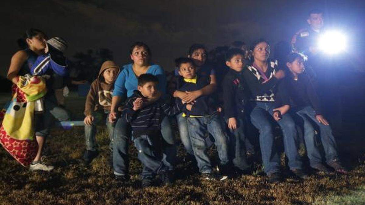 
A group of immigrants from Honduras and El Salvador who crossed the U.S.-Mexico border illegally were stopped in Granjeno, Texas. The U.S. has been contending with a flood of children and families from Central America crossing the border in recent months.
