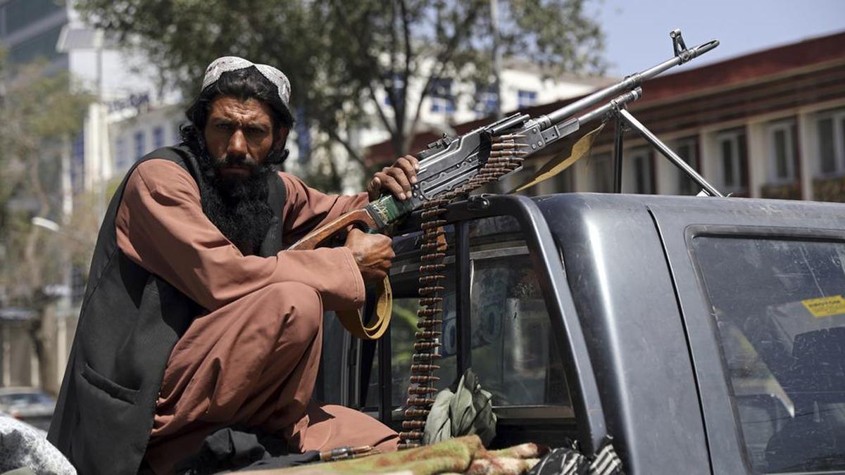 A Taliban fighter sits on the back of a vehicle with a machine gun in front of the main gate leading to the Afghan presidential palace, in Kabul, Afghanistan, Monday, Aug. 16, 2021. The U.S. military has taken over Afghanistan’s airspace as it struggles to manage a chaotic evacuation after the Taliban rolled into the capital. (AP Photo/Rahmat Gul)