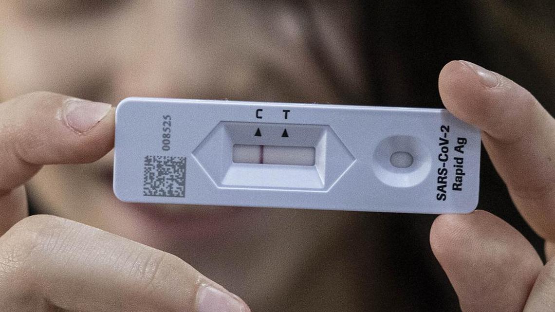 Ariel Kahana, 10, shows her COVID-19 Antigen test result, ahead of the first day of school, at her home in Moshav Talmey Yafe, Israel, Tuesday, Aug. 31, 2021.