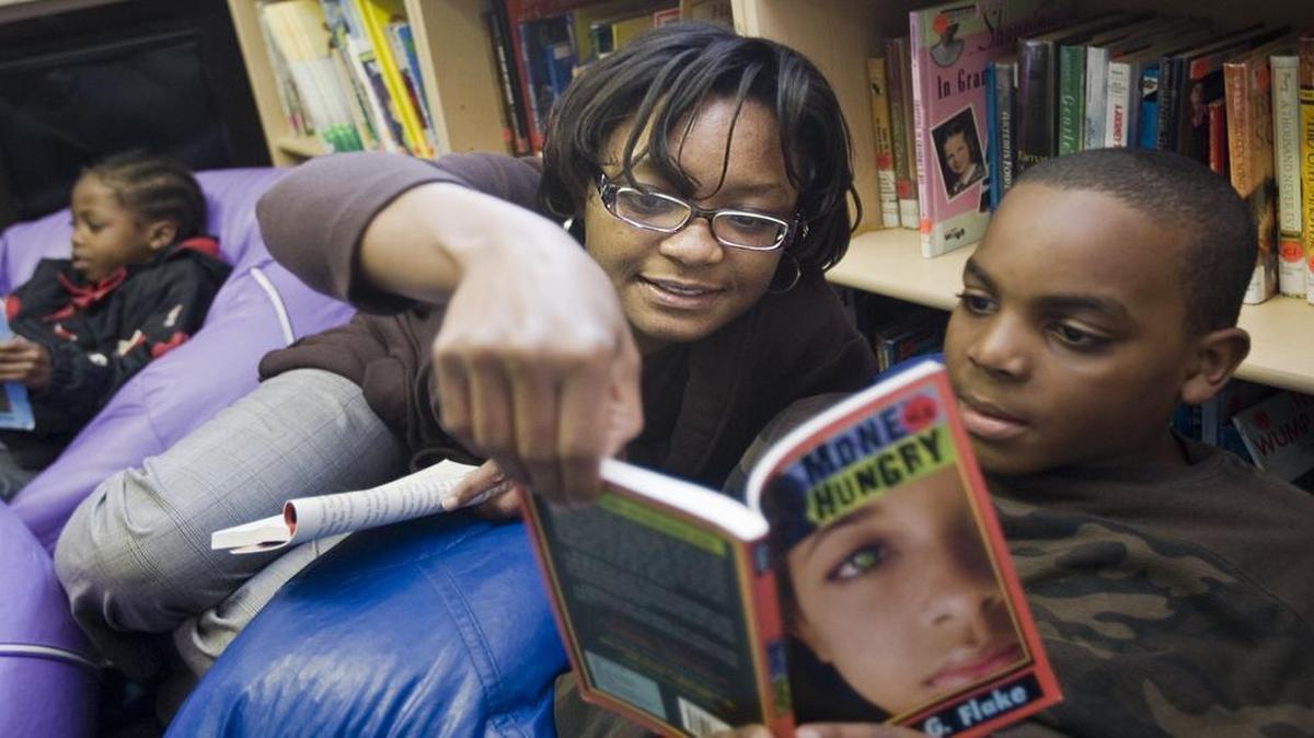 
Katherine Ray of Overland Park read with Marvellis Miller, 8, as she volunteered with inner-city children at one of the KC Urban Youth Center sites in the Rosedale Ridge Apartments in Kansas City, Kan.
