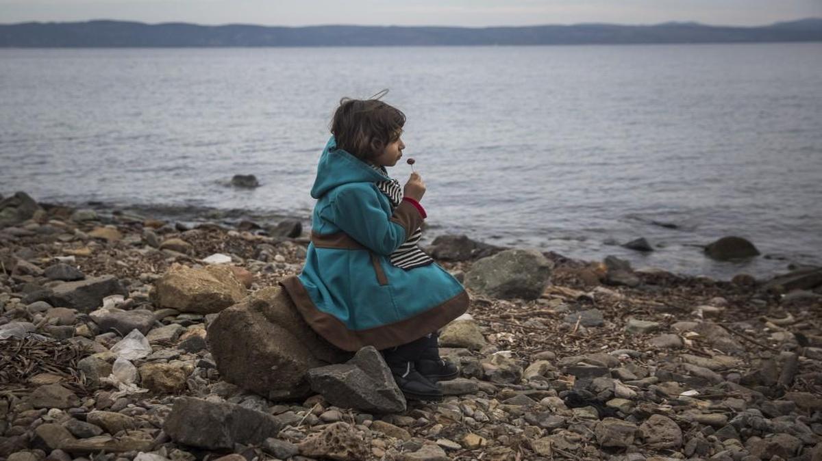 A Syrian girl ate a lollipop after her arrival on a small boat from the Turkish coast on the northeastern Greek island of Lesbos.