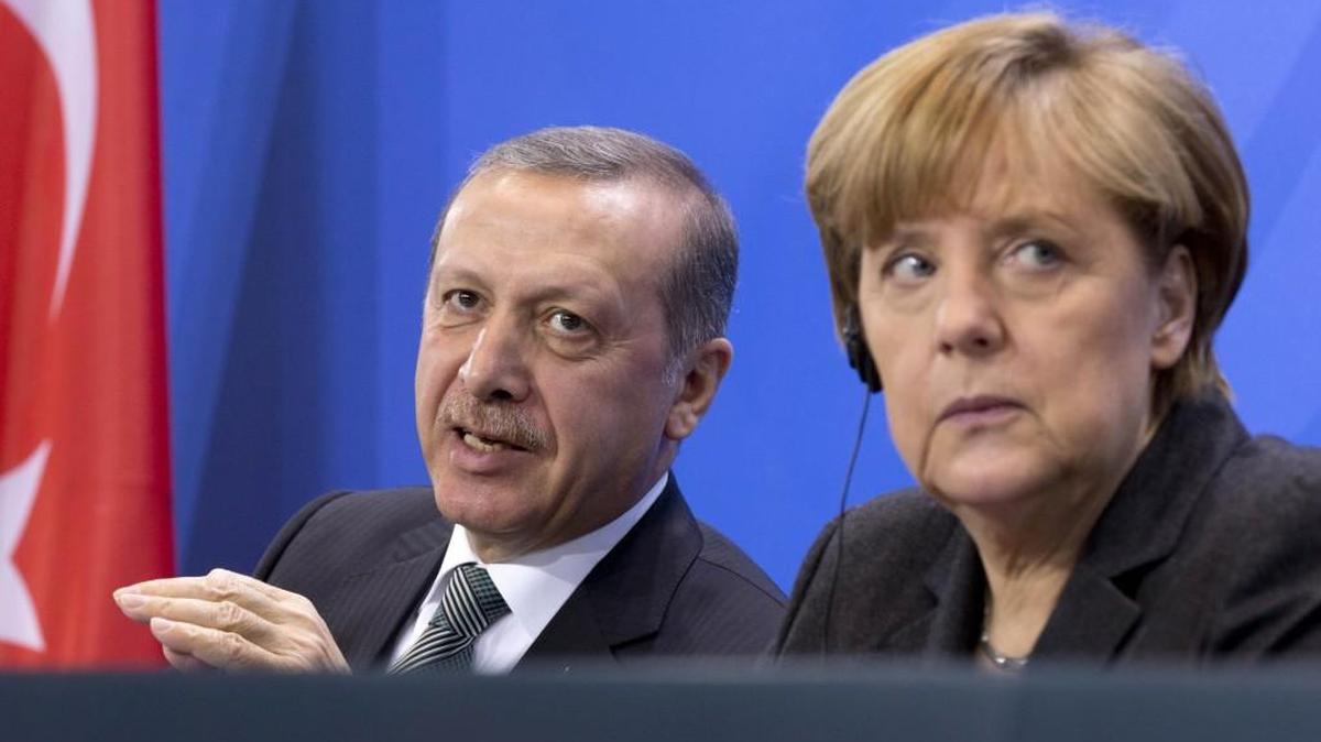 German Chancellor Angela Merkel (right) listened as Turkish President Recep Tayyip Erdogan (left) spoke at a news conference after a meeting at the chancellery in Berlin.