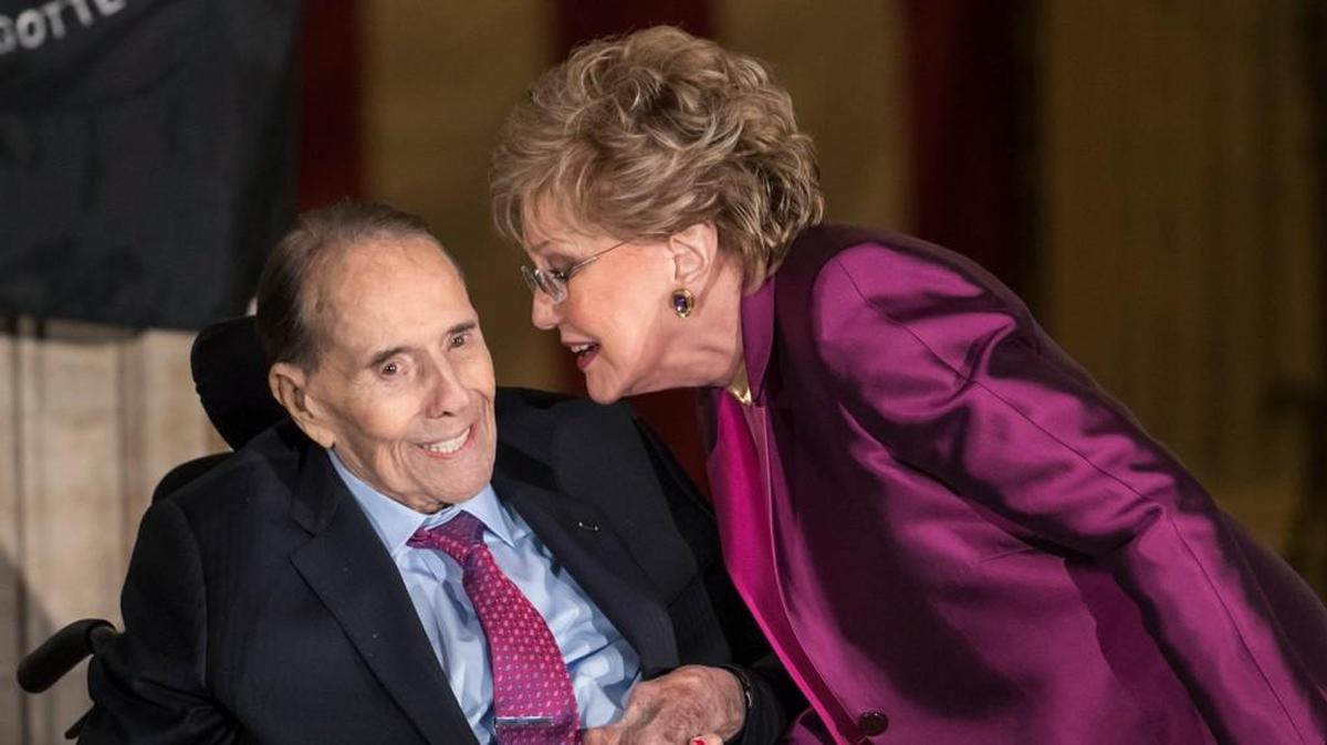 Former Senate Majority Leader Bob Dole smiles as he gets a kiss from his wife Elizabeth Dole as he is honored at the Capitol with a Congressional Gold Medal on Jan. 17, 2018.