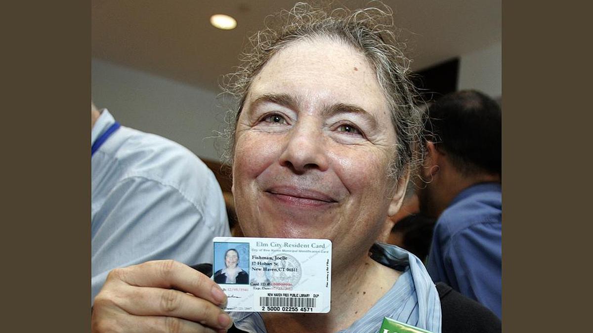 Joelle Fishman poses with her new New Haven municipal ID card at City Hall in New Haven, Connecticut, on July 24, 2007, the first day that residents could obtain the cards being offered to all the city’s 125,000 residents.