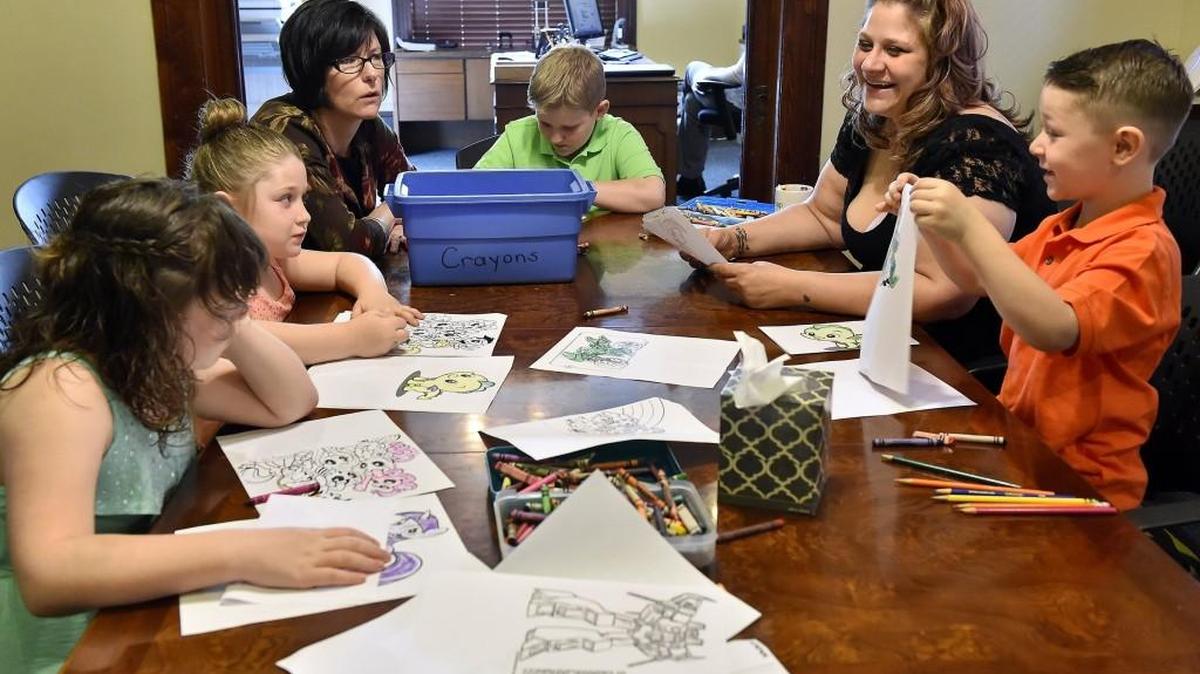 Nicole Staller of Independence, second from right, is in a good place with her children and life with the help of CASA volunteer Kate Beem, third from left, who helped Staller navigate the court system after losing custody of her children.