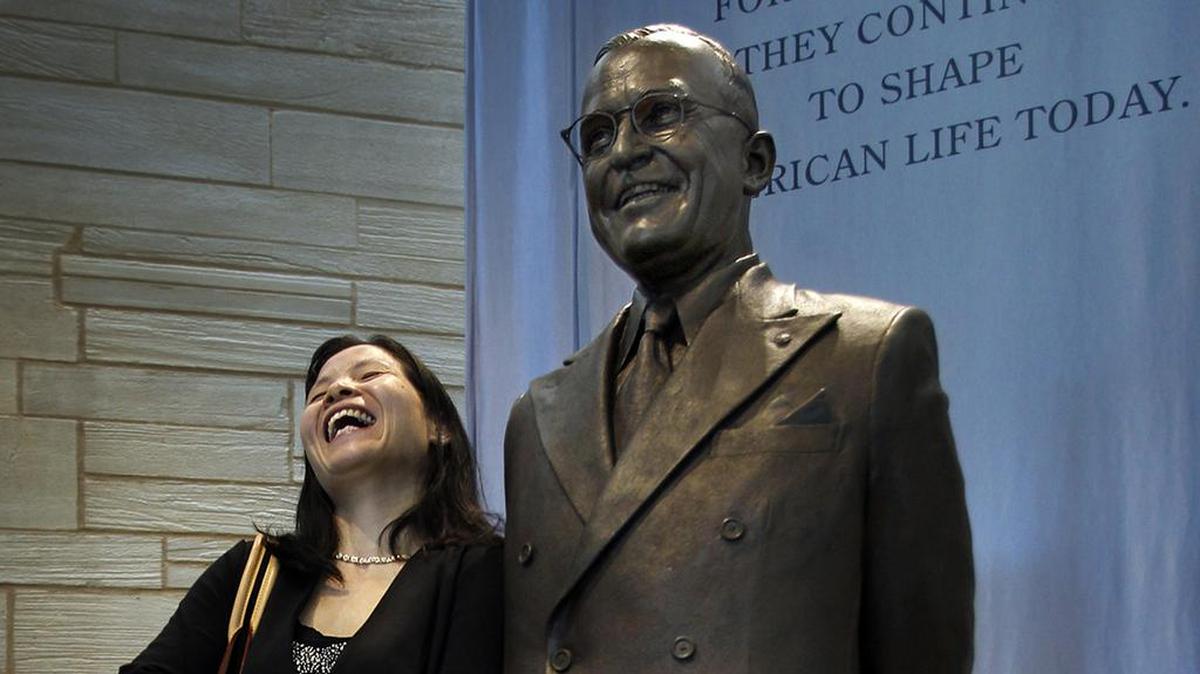 Ming Xue Liu of Lee’s Summit posed with a Truman statue so friends from the Lee’s Summit Community Church could get a picture after a naturalization ceremony in 2013.