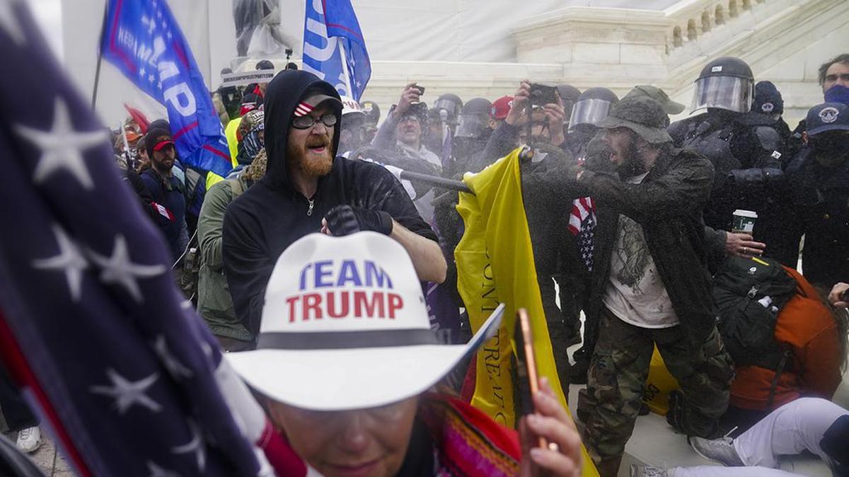FILE - In this Jan. 6, 2021, file photo, rioters try to break through a police barrier, at the Capitol in Washington. (AP Photo/John Minchillo, File)