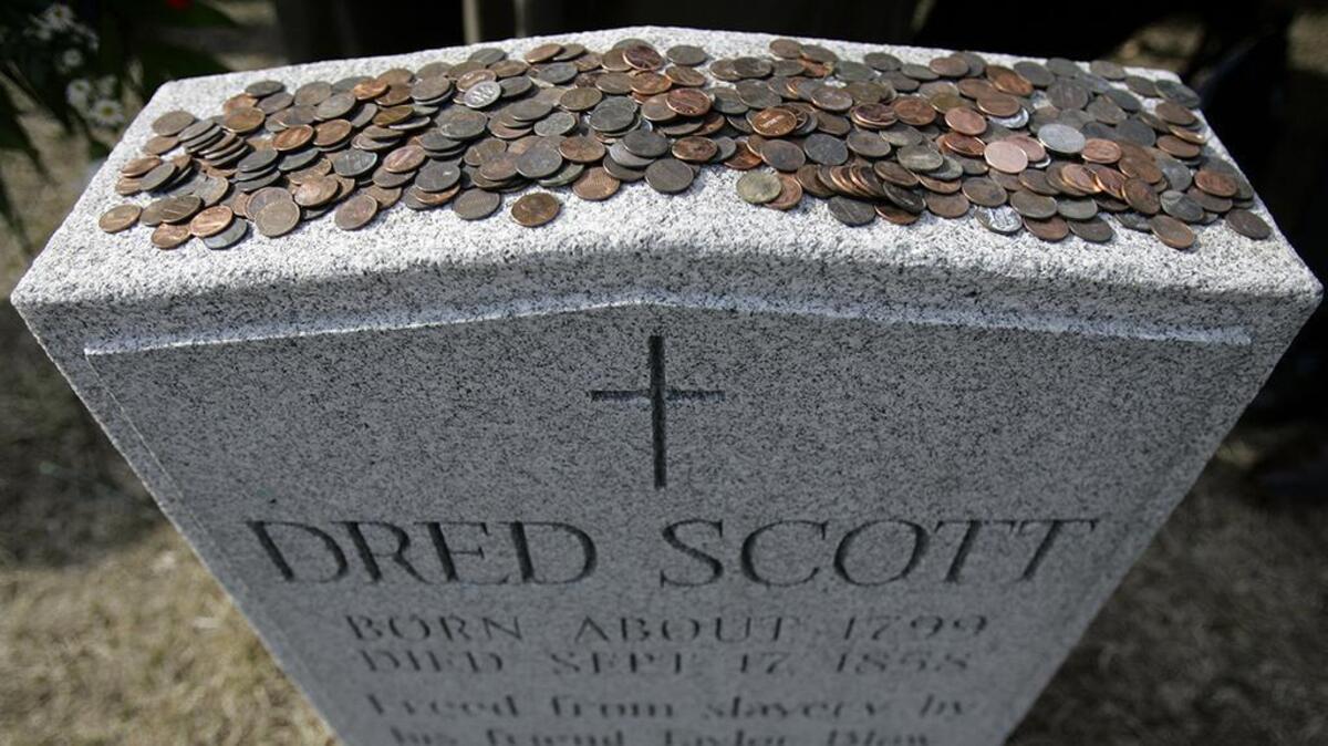 Pennies rest on top of the headstone marking Dred Scott’s grave in St. Louis’ historic Calvary Cemetery, honoring President Abraham Lincoln’s role in freeing the slaves.