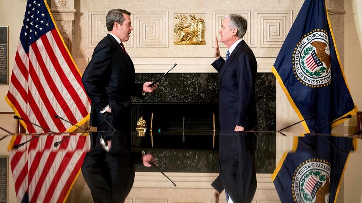 Jerome Powell, right, takes the oath of office as Federal Reserve board chair from Fed board Vice Chairman for Supervision Randal Quarles.