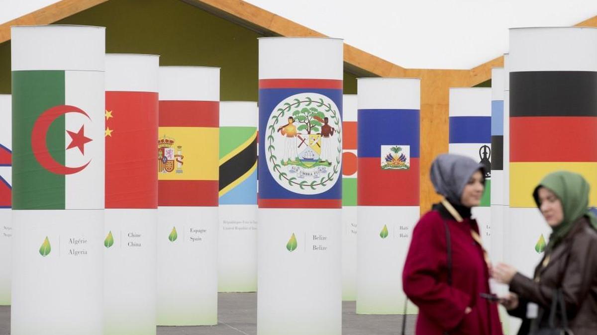 National flags sat on columns outside the United Nations climate summit at Le Bourget in Paris, France.
