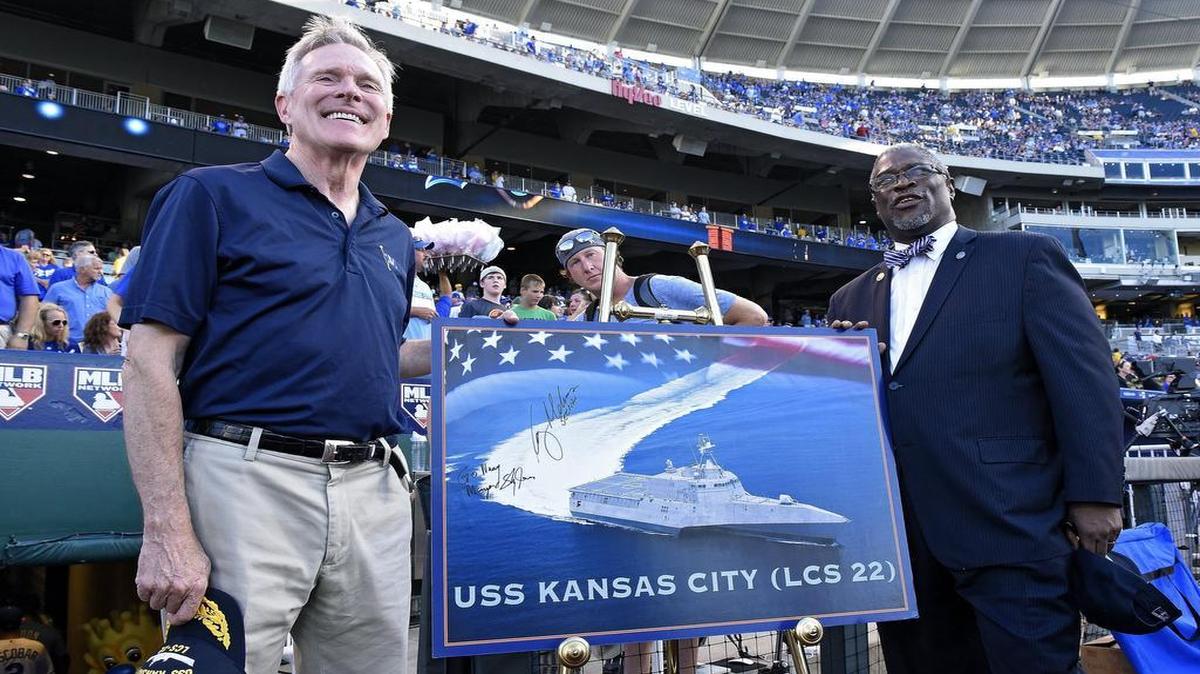 
Secretary of the Navy Ray Mabus (left) and Mayor Sly James of Kansas City posed with an image of the planned USS Kansas City before Monday’s baseball game between the Kansas City Royals and the Pittsburgh Pirates.
