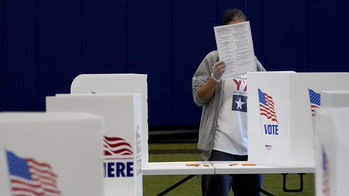 A woman checks her ballot as she votes at the MLB Urban Youth Academy Tuesday, Nov. 3, 2020, in Kansas City, Mo. (AP Photo/Charlie Riedel)