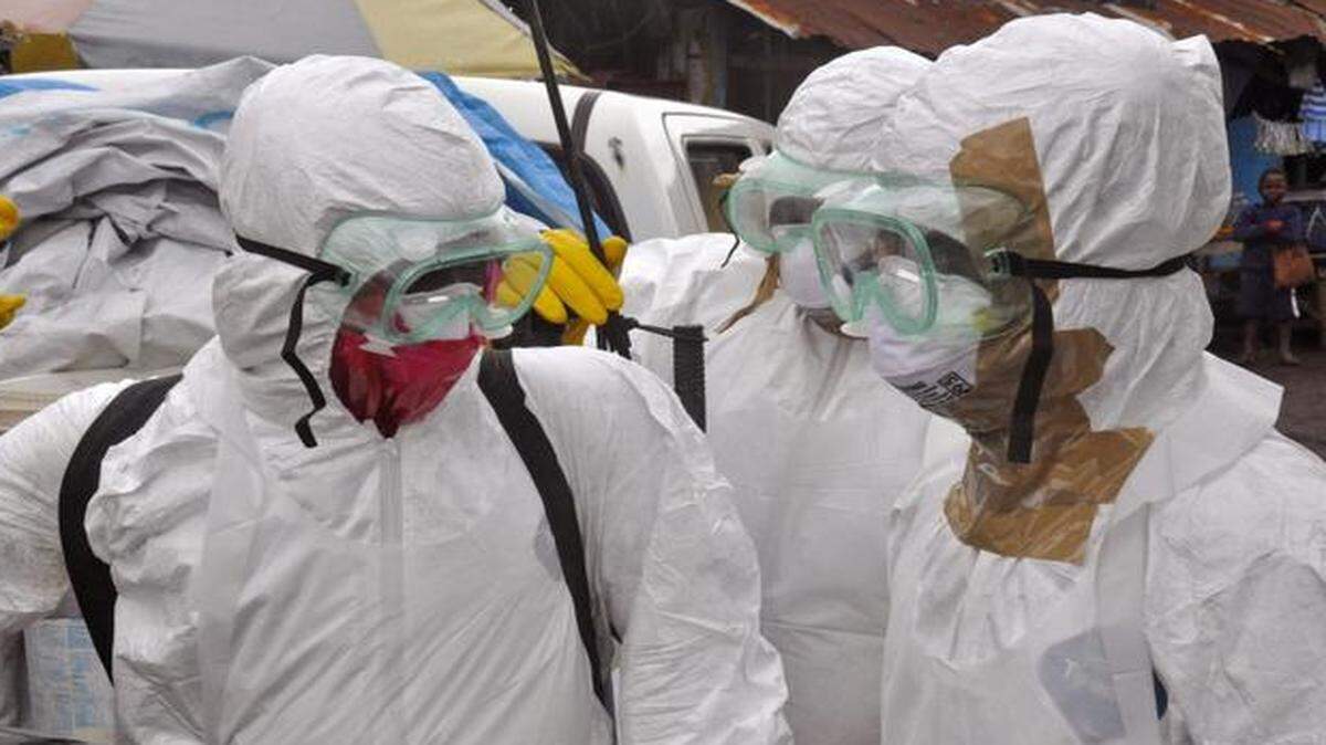 
Health workers in protective gear left after carrying the body of a woman that they suspected died from the Ebola virus in an area known as Clara Town in Monrovia, Liberia, earlier this month.

