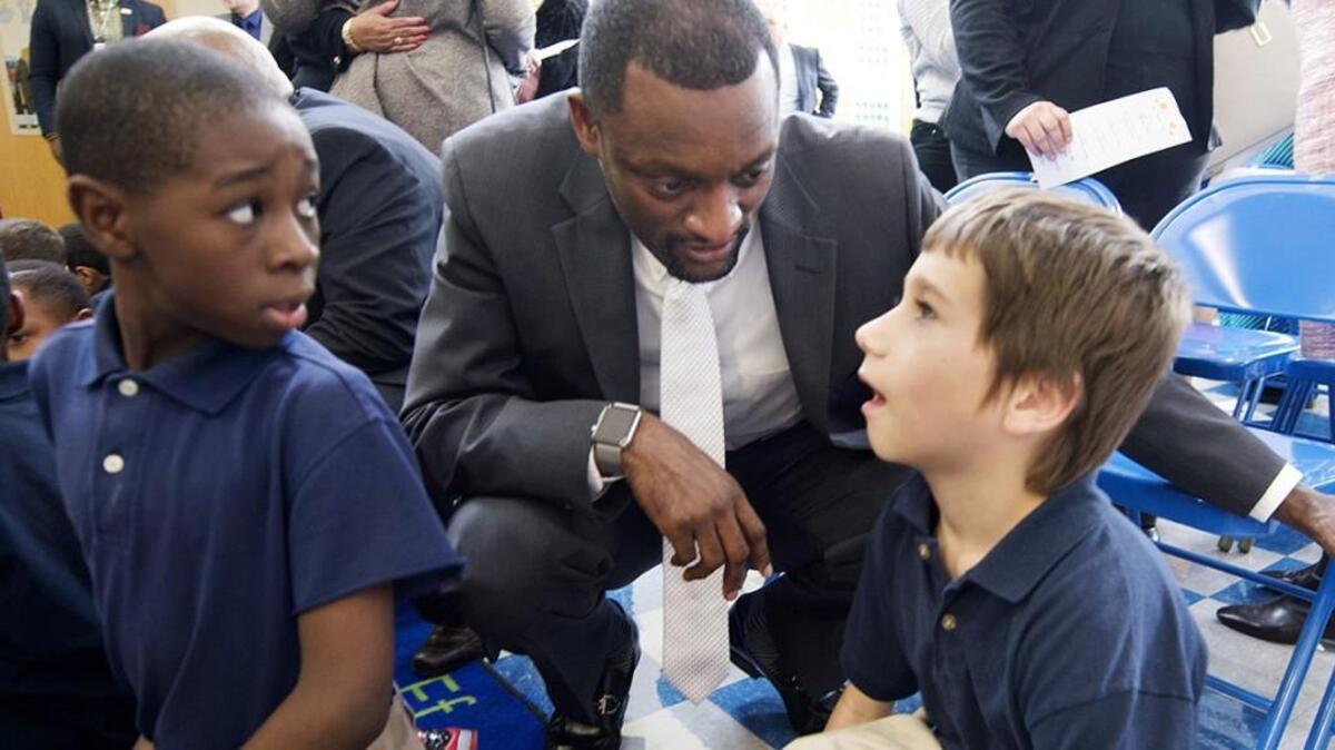 Wendell Phillips Elementary school student, Currency Marshall (left) listened as the Kansas City Public School Superintendent Mark Bedell talked with classmate Noah Adams.