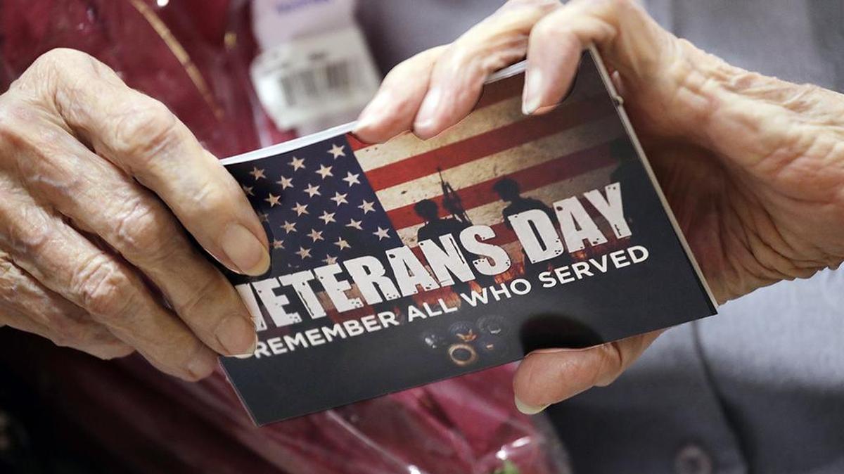 U.S. Army Nurse Corps veteran Frances E. Harman, 98, who served as a first lieutenant in World War II, holds a card given to her during a ceremony honoring her service Nov. 8 in Seattle at the annual VA Puget Sound Veterans Day event. She served in the burn unit of a field hospital in New Guinea.