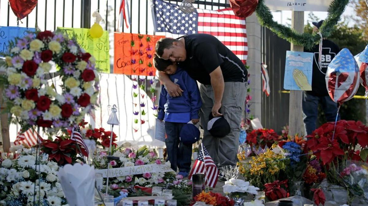Gary Mendoza and his son Michael paid their respects at a makeshift memorial site honoring shooting victims in San Bernardino, Calif.