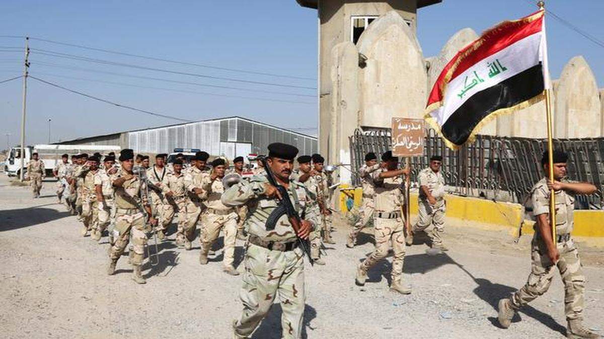 
Iraqi Army soldiers parade inside the main army recruiting center during a recruiting drive for men to volunteer for military service in Baghdad.
