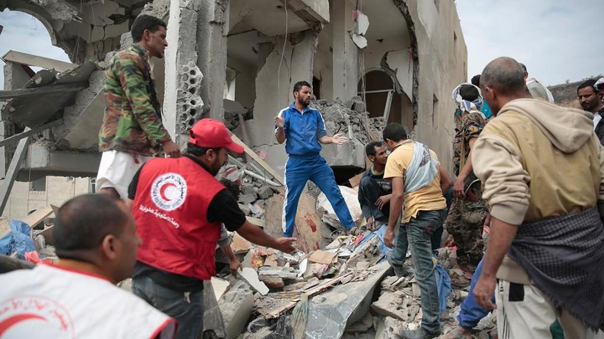 In this Aug. 25, 2017 file photo, People search under the rubble of houses destroyed by Saudi-led airstrikes in Sanaa, Yemen.