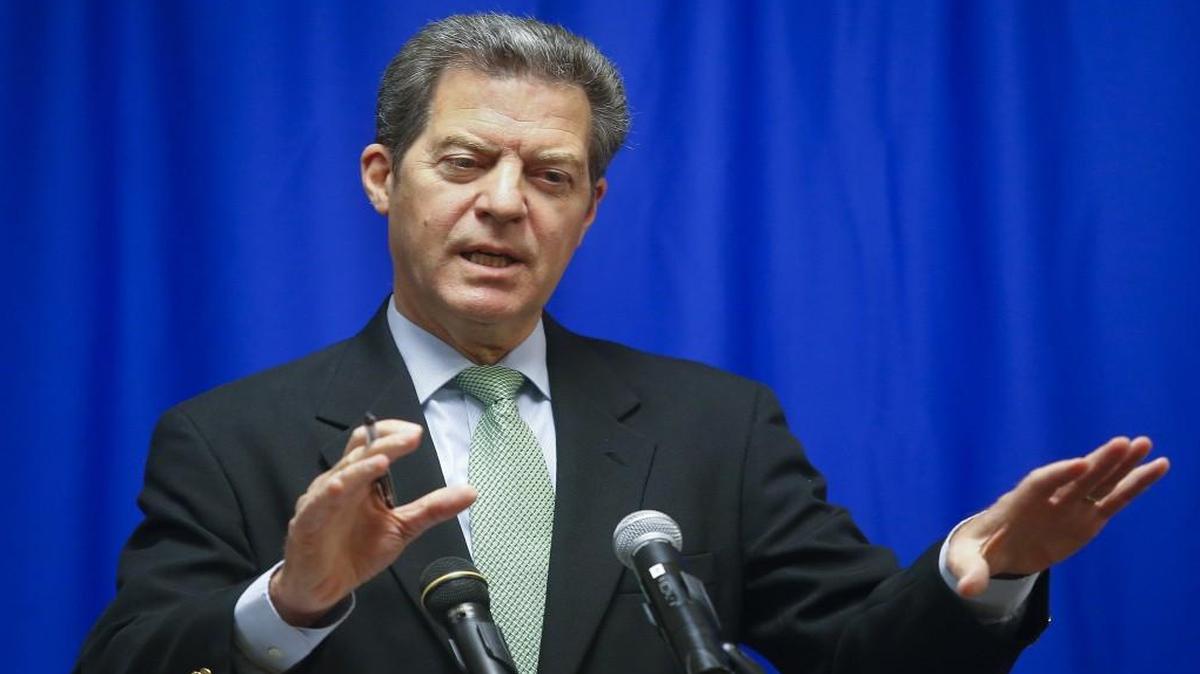 Kansas Gov. Sam Brownback discusses the difficulty behind approving and funding a budget at a news conference at the Kansas Statehouse in Topeka. His tax cuts have forced the state to delay payments to the Kansas Public Employee Retirement System.