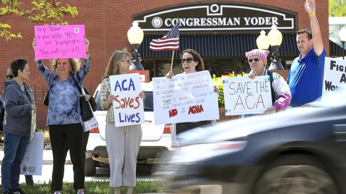 Protesters outside Kansas Congressman Kevin Yoder’s Overland Park office in May.