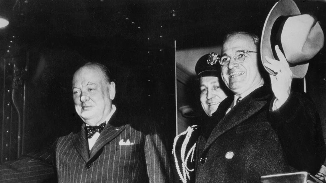 Former British Prime Minister Winston Churchill, left, and President Harry S. Truman wave goodbye from the President's special train as they depart, from Washington, on March 9, 1946, for Fulton, Missouri.