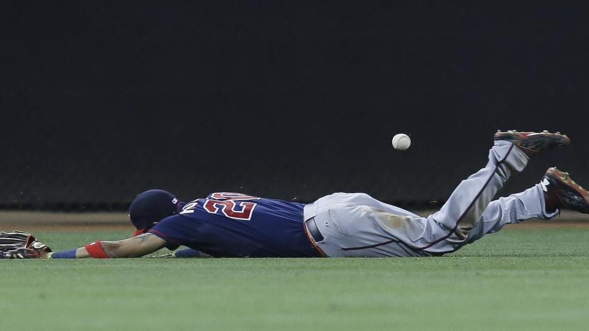 
Minnesota Twins left fielder Eddie Rosario missed a double hit by Cincinnati’s Tucker Barnhart in the sixth inning of Monday’s game.
