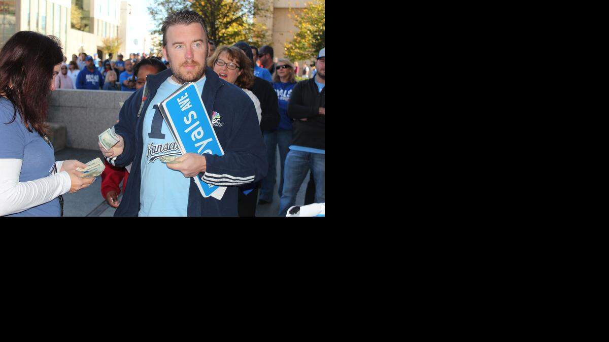 
Michael Butler, a former Carl Junction, Missouri, resident now livingi in from New York, handed over his $30 and was the last person to buy a Royals Ave. street sign at City Hall Wednesday morning, much to the dismay of the people lined up behind him
