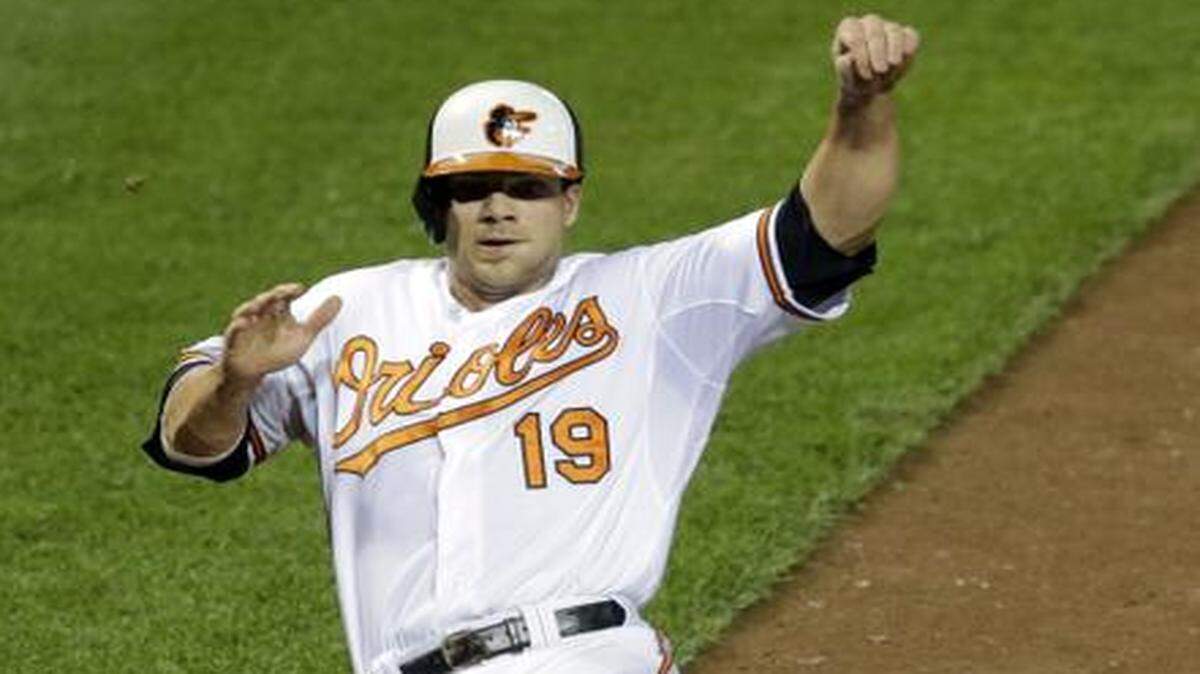 
The Baltimore Orioles’ Chris Davis slid into home plate for a run on Aug. 26 against the Rays. Baltimore will be without Davis for the ALCS.


