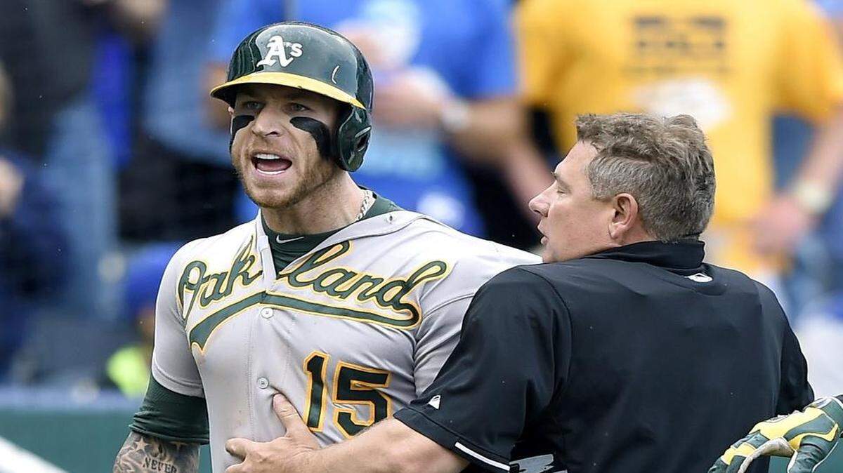 
Oakland’s Brett Lawrie was restrained by home plate umpire Greg Gibson after Royals relief pitcher Kelvin Herrera was ejected by Gibson for pitching inside to Lawrie in the eighth inning of Sunday’s game at Kauffman Stadium.
