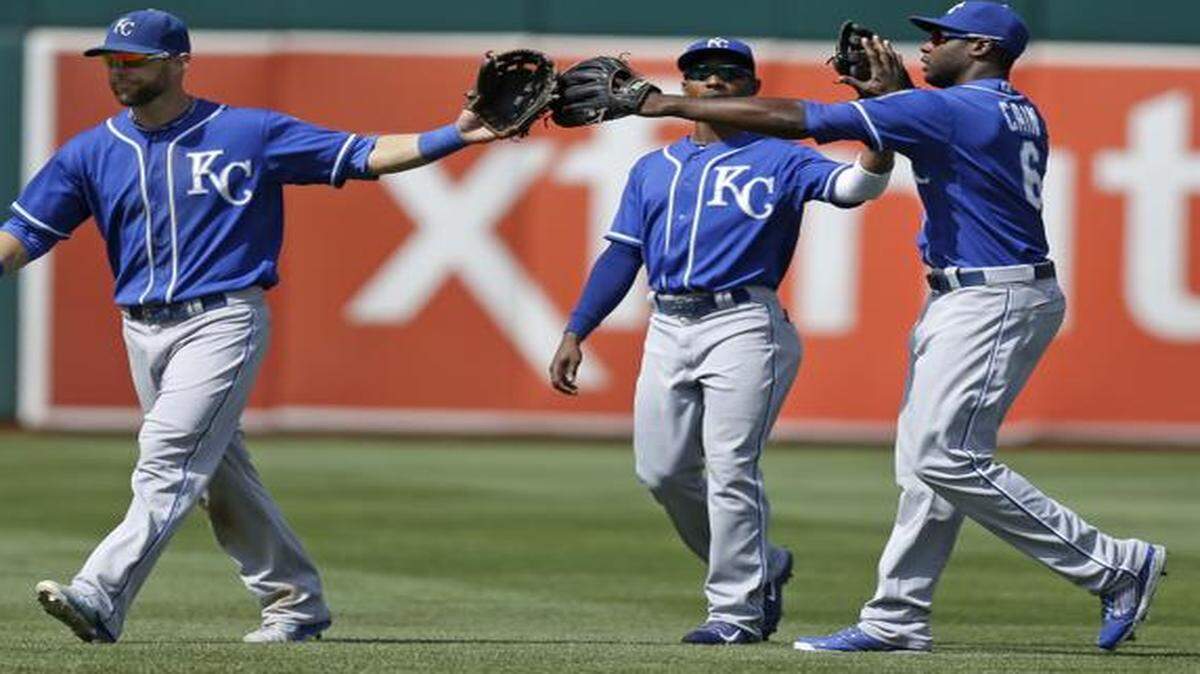 
From left, Kansas City Royals outfielders Alex Gordon, Jarrod Dyson, and Lorenzo Cain celebrated the 4-2 defeat of the Oakland Athletics on Sunday in Oakland, Calif. 

