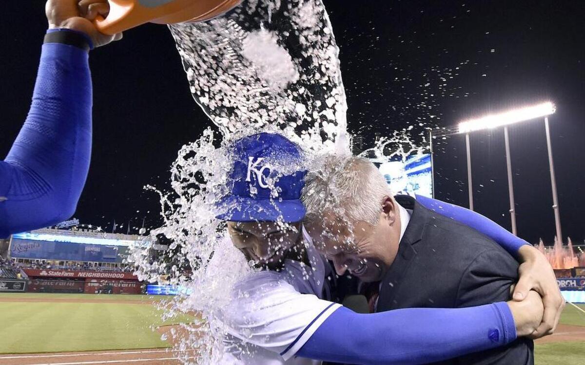 Kansas City Royals first baseman Eric Hosmer (left) and Fox Sports KC broadcaster Joel Goldberg tried to avoid Salvador Perez’s ice bucket after a Royals win on September 8, 2015 at Kauffman Stadium in Kansas City, Mo.