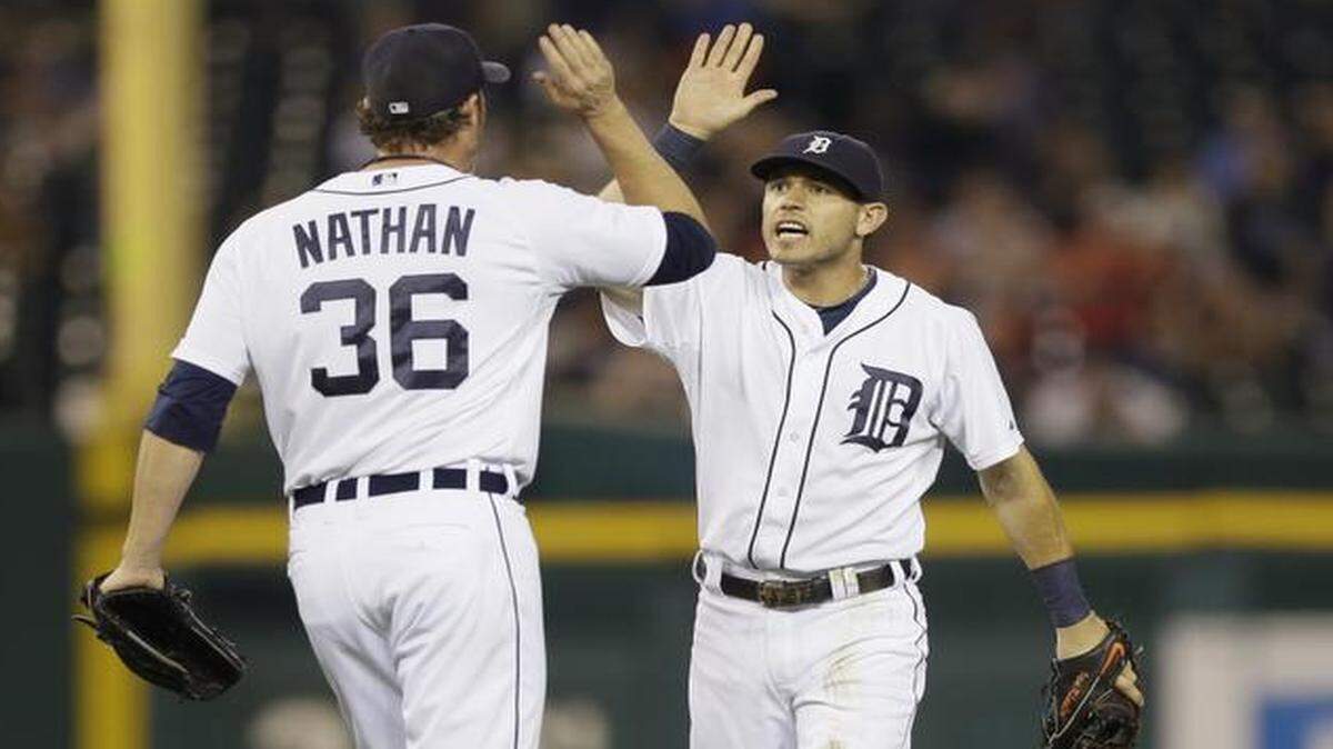 
Detroit Tigers relief pitcher Joe Nathan and second baseman Ian Kinsler celebrate after catching Kansas City Royals pinch-runner Jarrod Dyson off second base during the ninth inning of Tuesday’s game.
