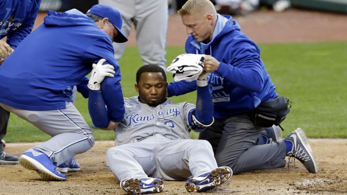 
Alcides Escobar was helped up by trainers after getting hit by a pitch from Cleveland Indians starting pitcher Danny Salazar in the fifth inning Wednesday.
