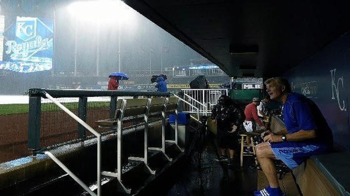 
Royals first-base coach Rusty Kuntz watched the rain fall Monday at Kauffman Stadium before the game against the Rays was postponed.

