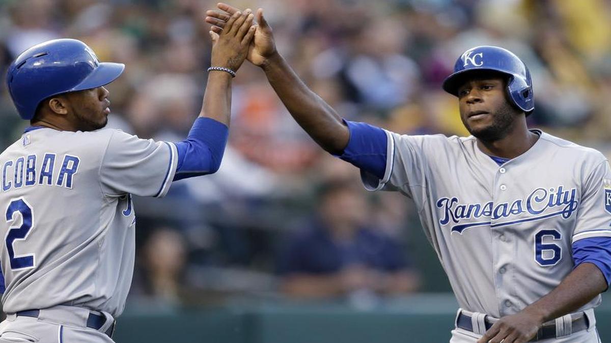 
The Royals' Alcides Escobar (left) and Lorenzo Cain celebrate after scoring against the Athletics during Friday’s baseball game in Oakland, Calif. Both scored on a single by Eric Hosmer.
